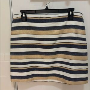 A short skirt. The colors are gold, white, and navy. The size is 10.